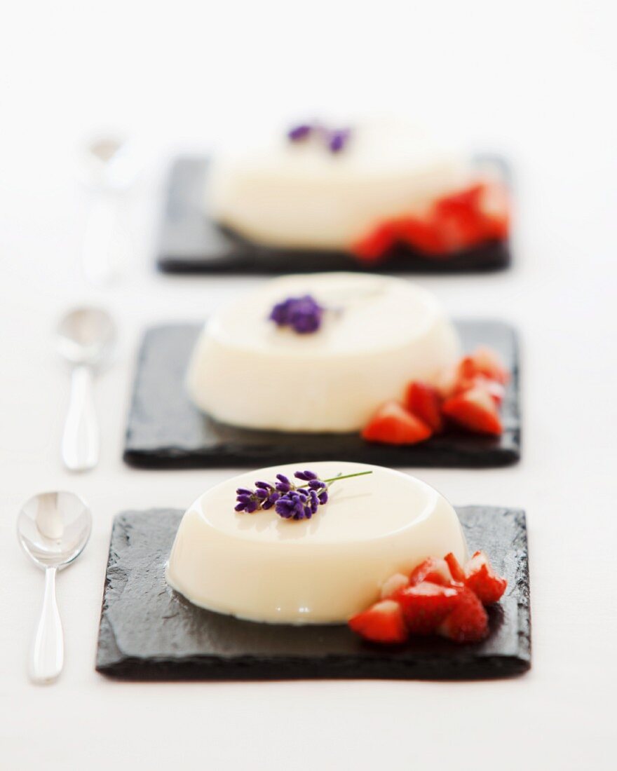 Panna cotta served with strawberries, lavender and lavender syrup