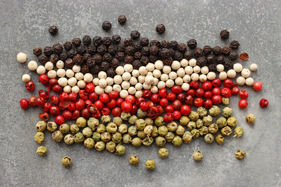 Rows of different coloured peppercorns