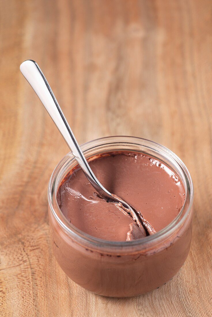 Chocolate cream in a glass with a spoon