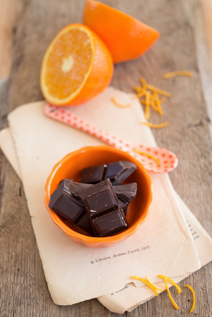 Pieces of chocolate, oranges and orange zest