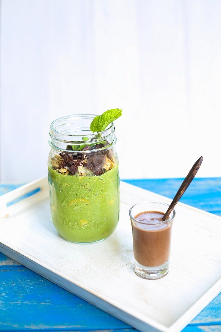 Breakfast parfait with pumpkin seed milk and cocoa nibs with chocolate sauce