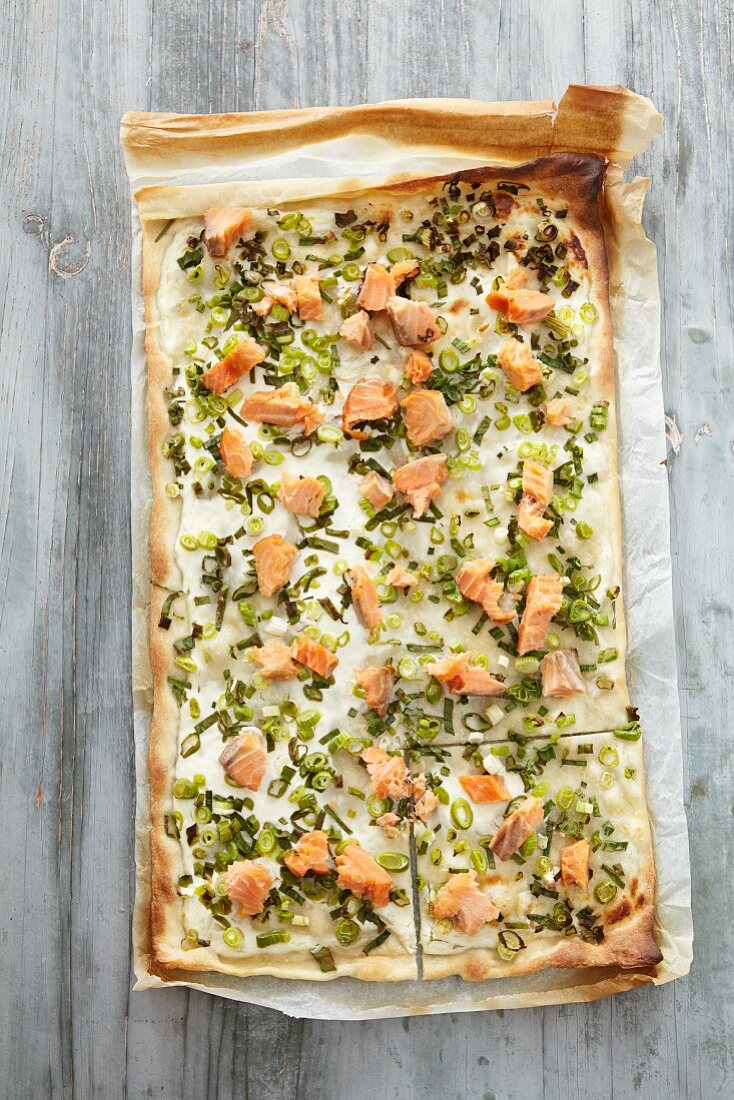 Tarte flambee with salmon trout and spring onions