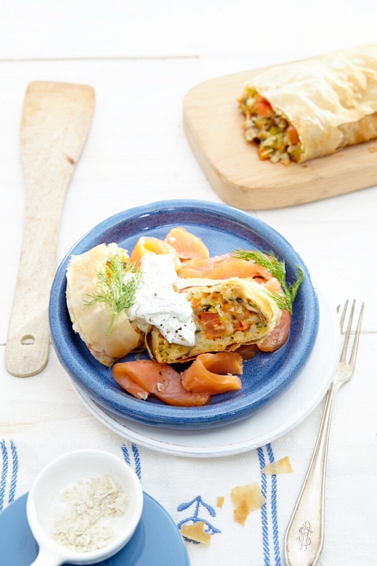 Vegetable strudel with smoked salmon and sour cream