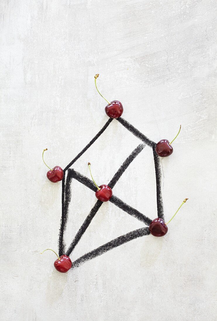 A geometric shape with cherries marking the corners