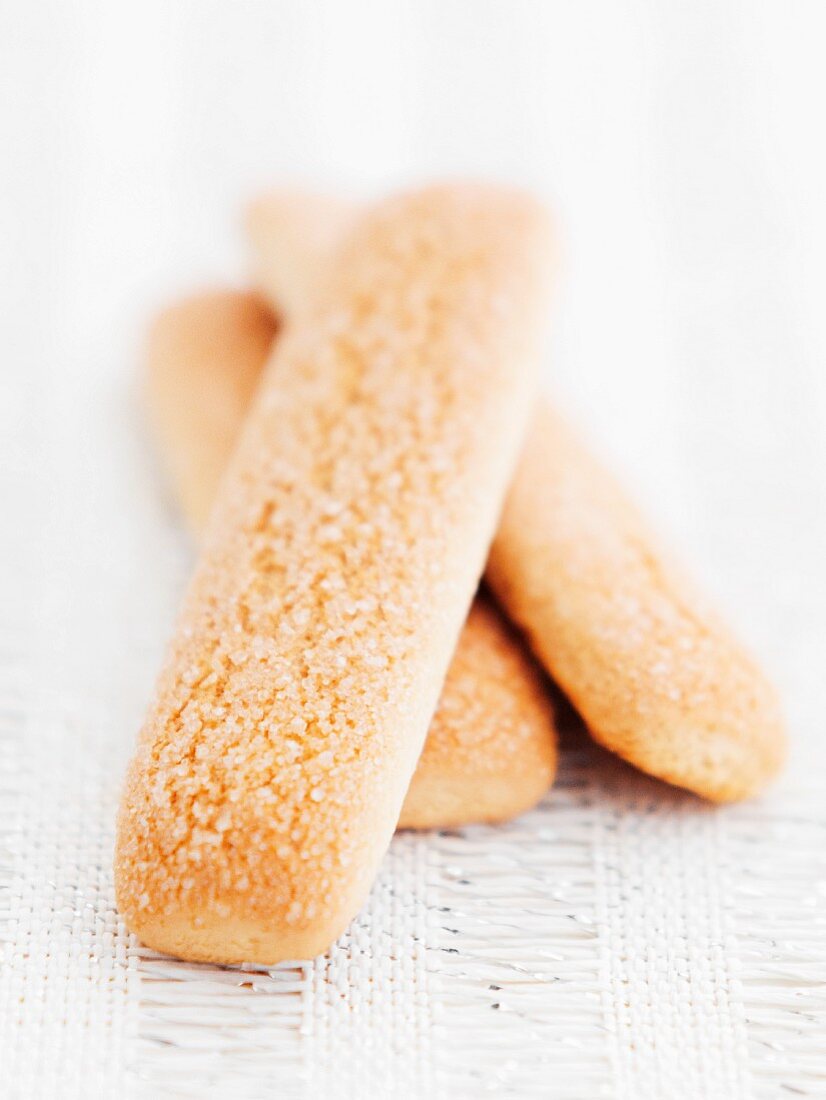 Three sponge finger biscuits on a place mat
