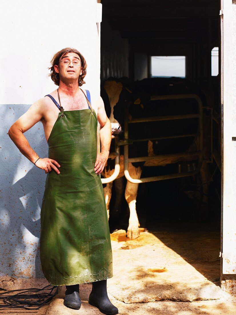 A farmer wearing an apron in front of a cowshed (Ibiza)