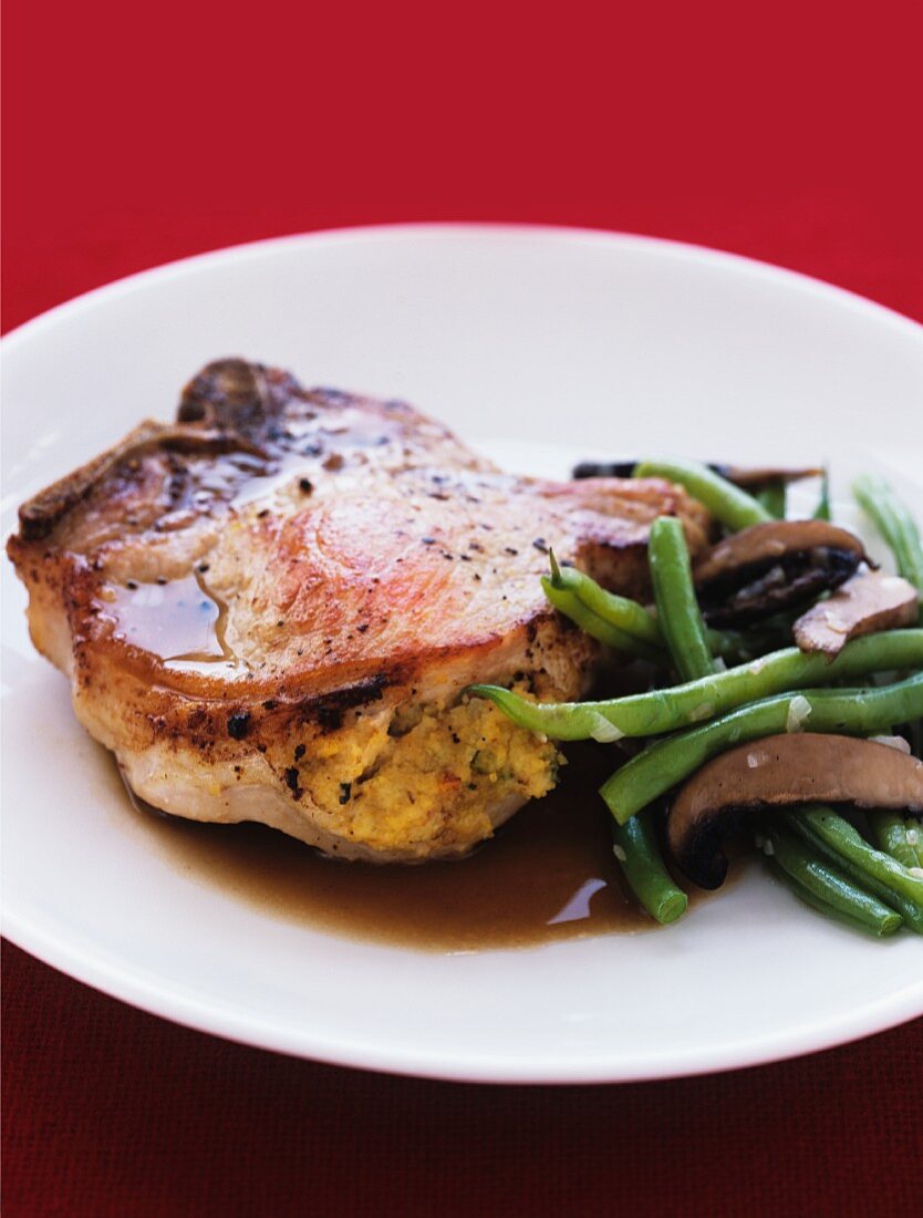 Stuffed pork chops with green beans and mushrooms