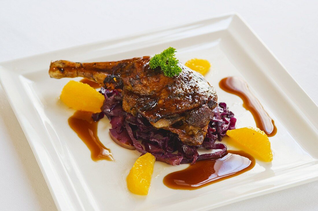 Duck leg with orange and red cabbage