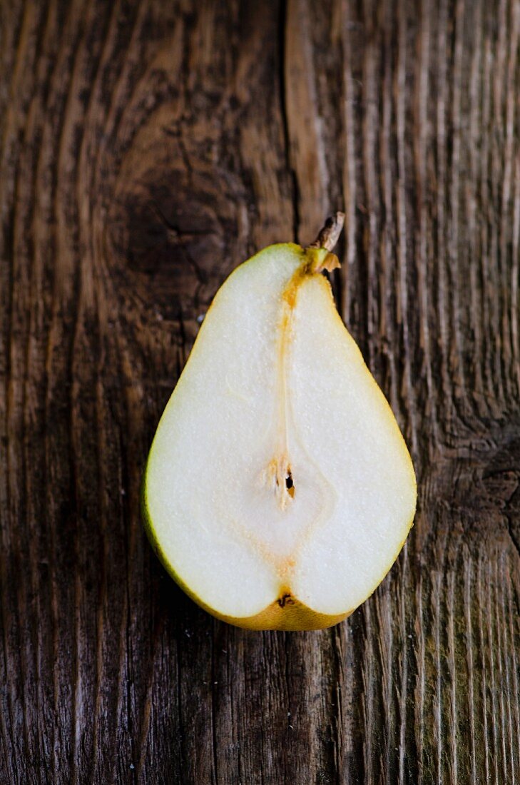 Half a pear on on wooden surface