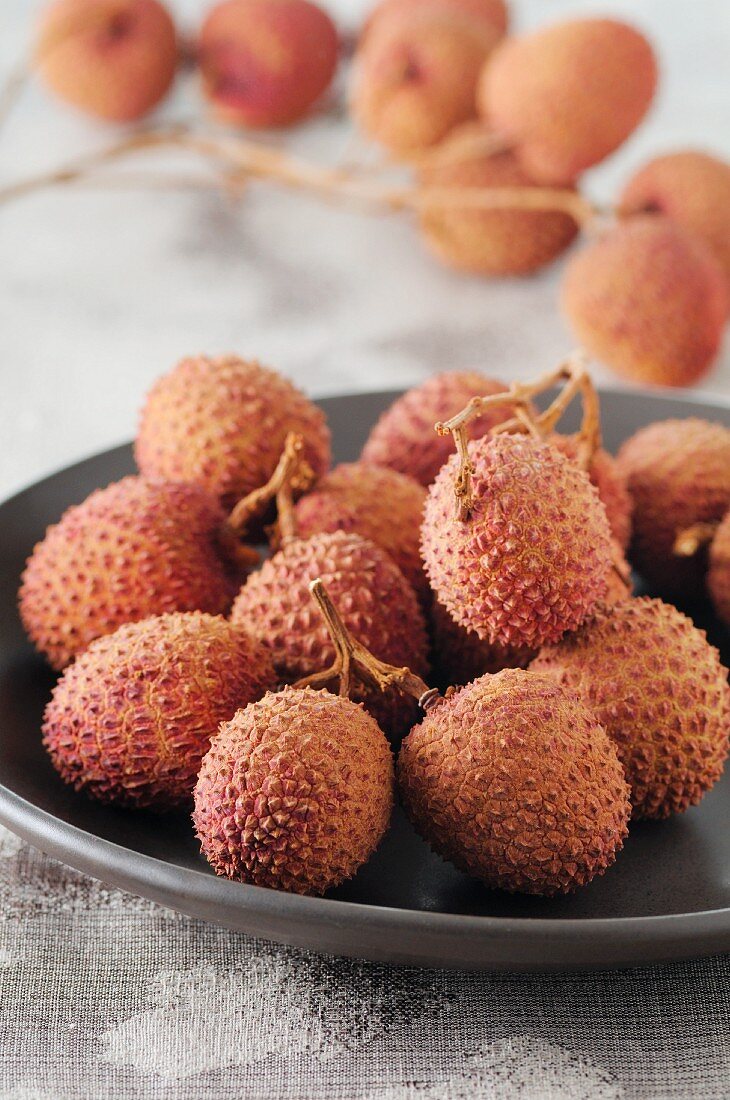 Lychees on a plate and next to it