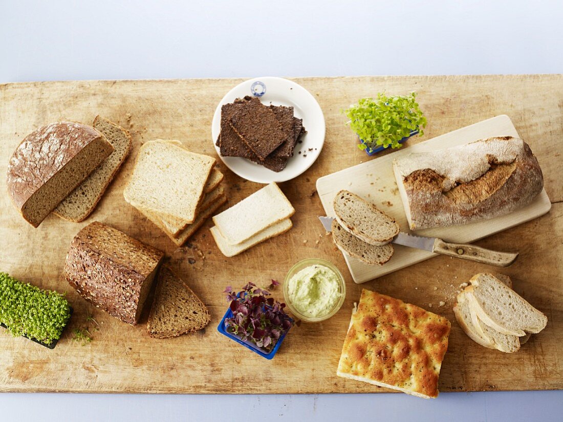 Various types of bread, fresh cress and spreads