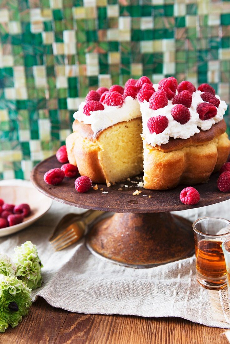 Baba with cream and raspberries