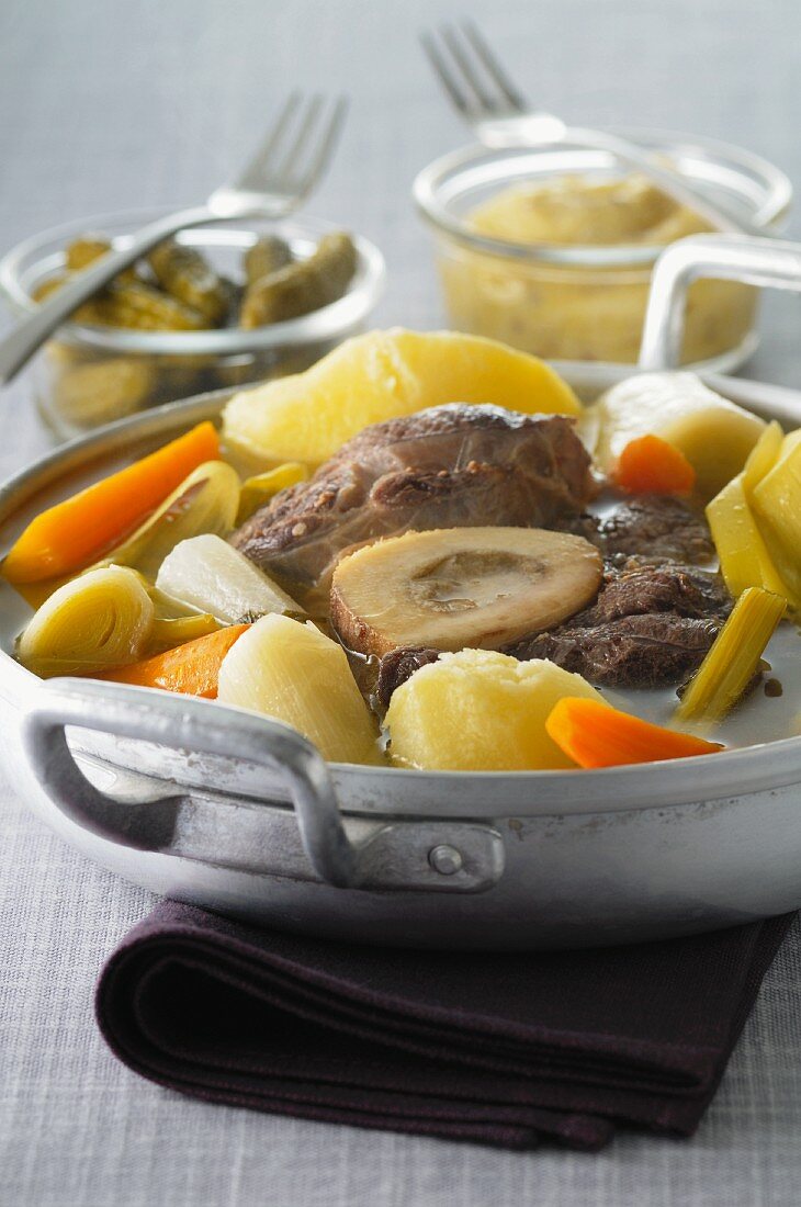 Pot au feu with beef, vegetables, gherkins and mustard