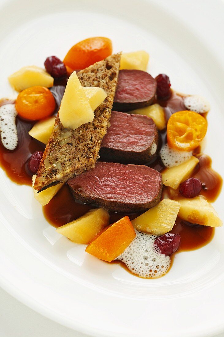 Saddle of venison with parsnips, kumquats and juniper cake