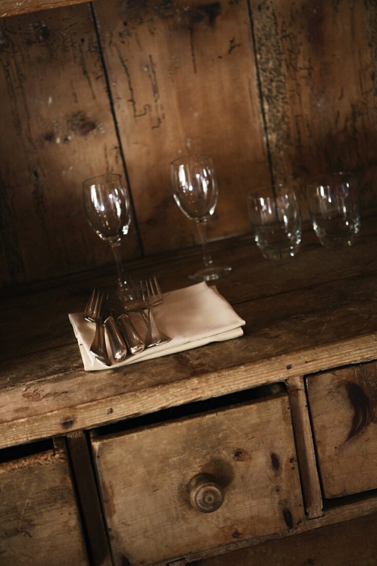 Glasses and cutlery on a rustic wooden table