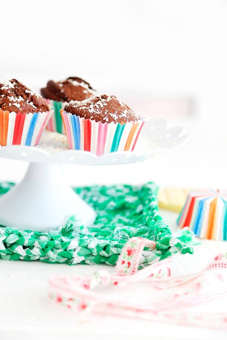 Chocolate muffins on a white cake stand