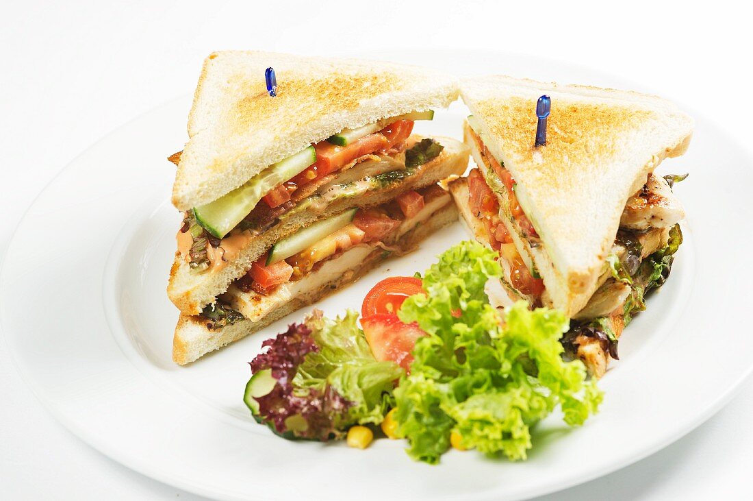 A club sandwich served with salad