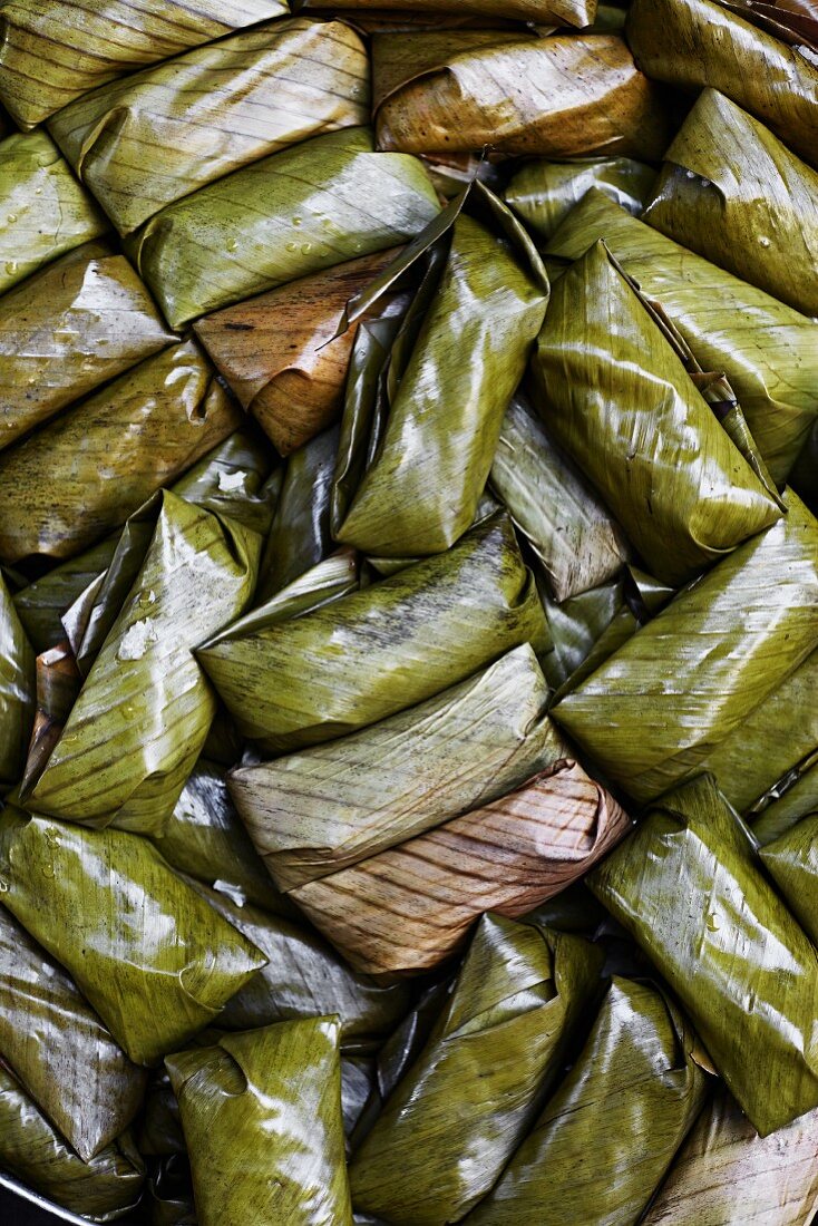 Khaw-tom (sticky rice with bananas wrapped in banana leaves and steamed, Thailand)