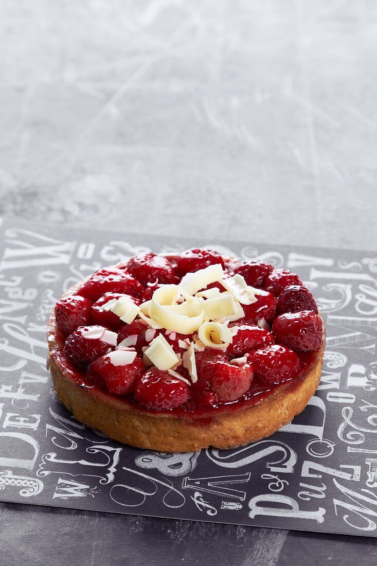 A raspberry tartlet topped with white chocolate