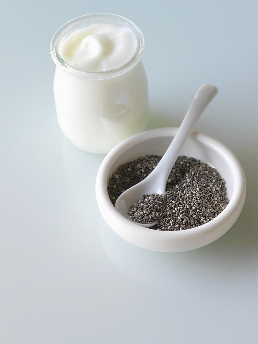 A jar of natural yogurt and a bowl of chia seeds