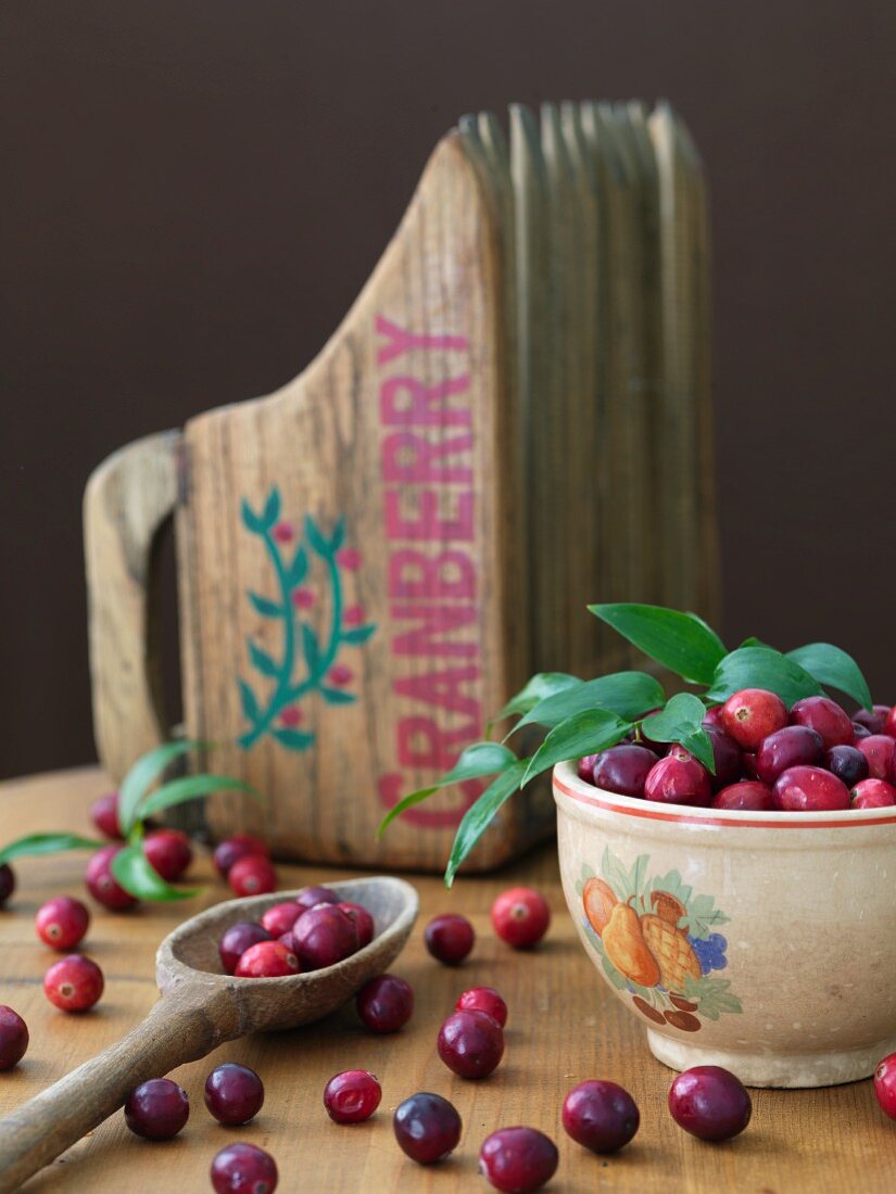 Fresh cranberries and a wooden cranberry scoop