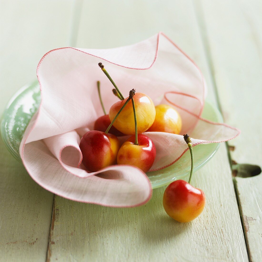Fresh sweet cherries on a cloth on a plate