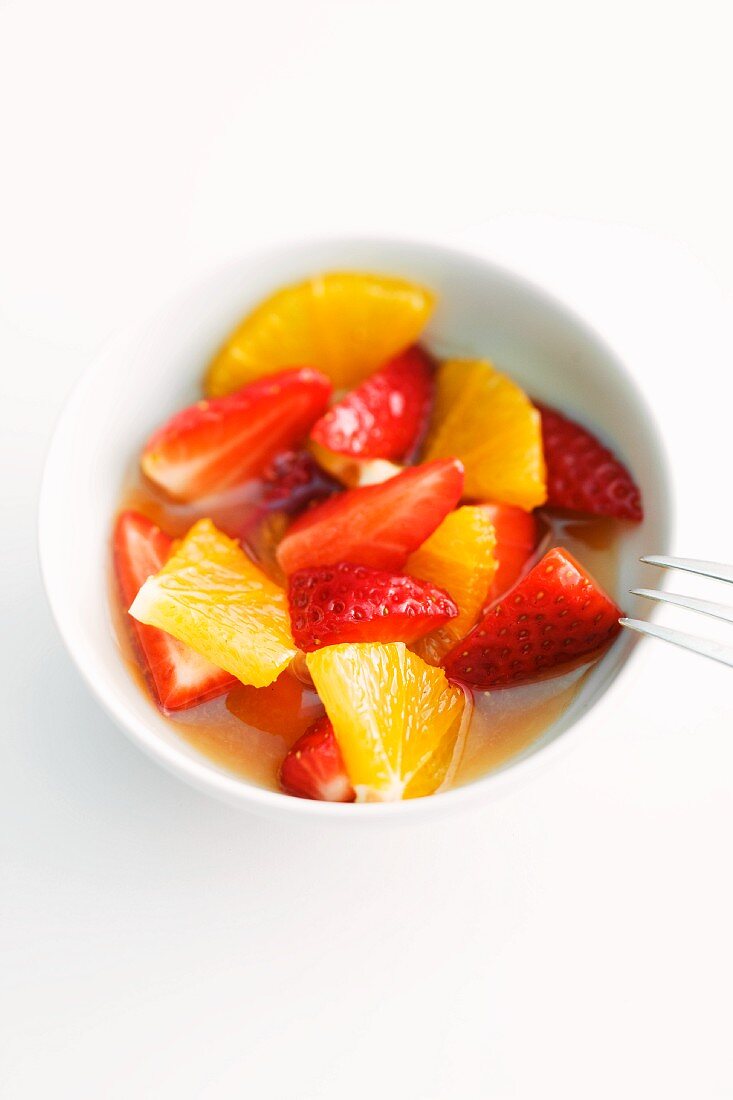 Fruit salad with marinated strawberries and oranges