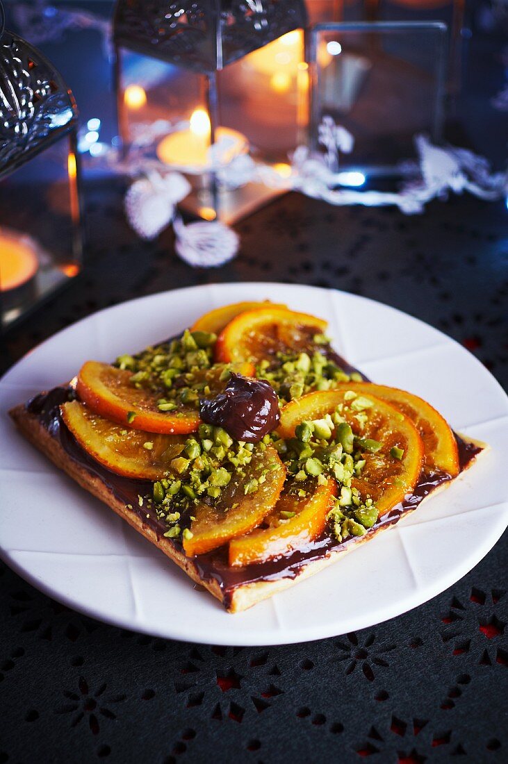 Chocolate tart with oranges and pistachio nuts