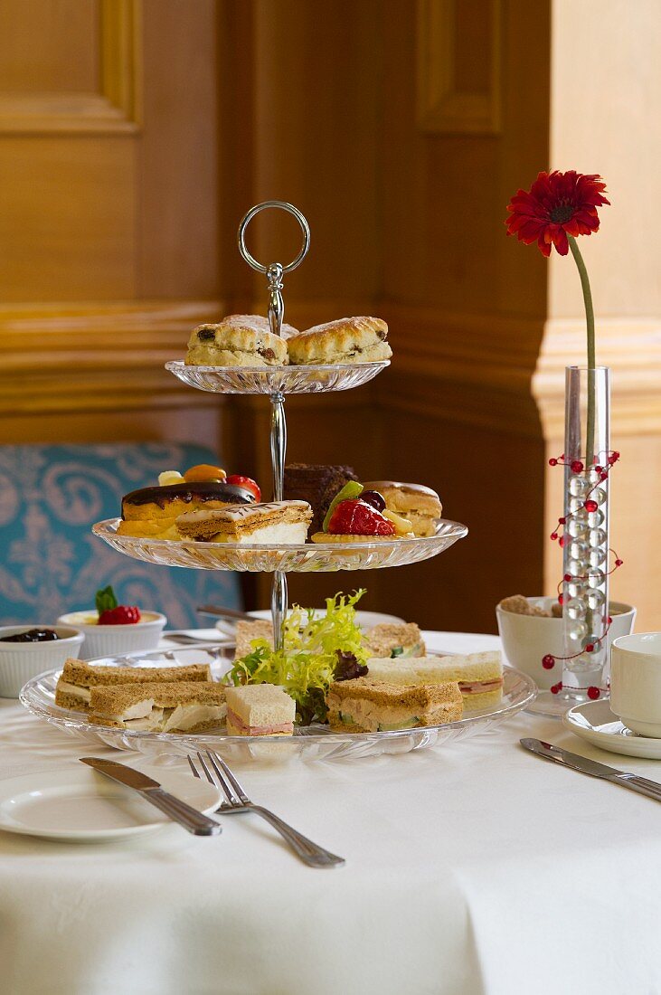 Biscuits, sweet pastries and sandwiches on a cake stand for high tea (England)