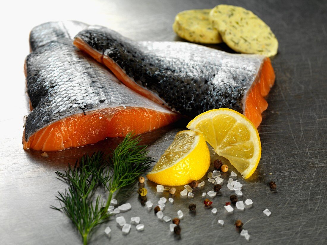 Raw salmon fillets with herb butter, lemon and dill