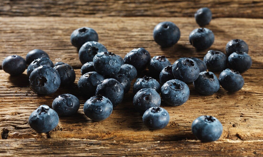 Freshly washed blueberries on a wooden surface