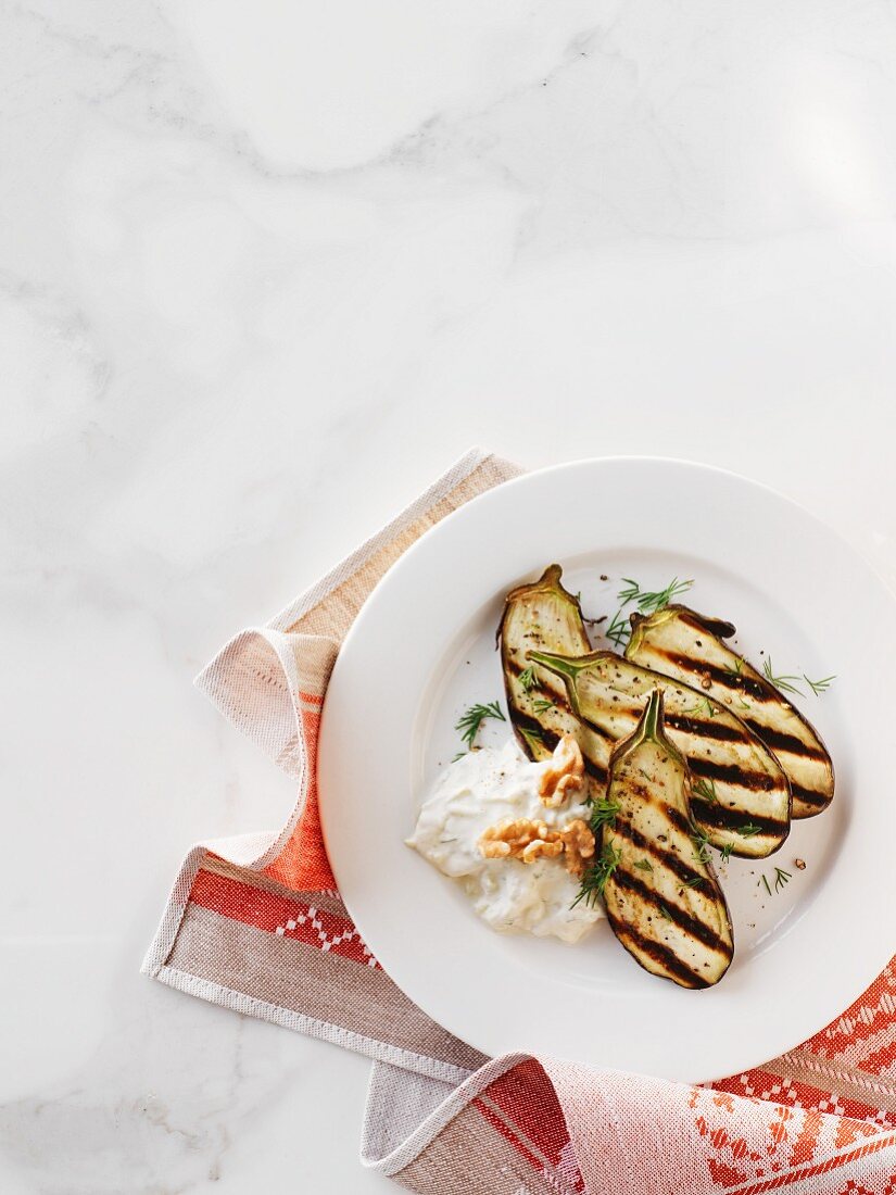 Grilled aubergine with tzatziki, dill and walnuts (Turkey)