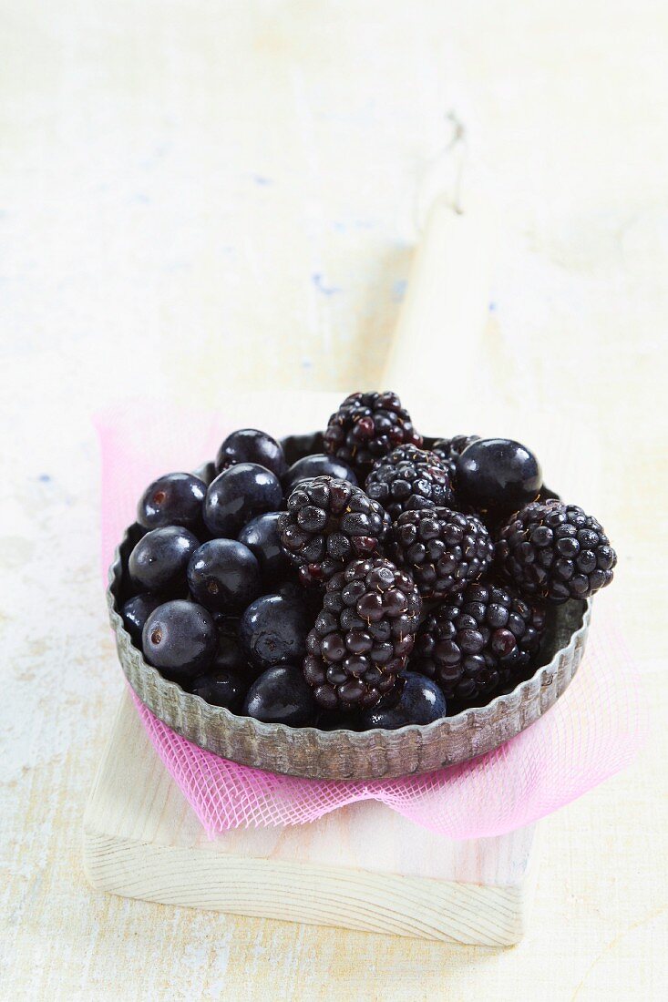 Blueberries and blackberries in a tartlet dish