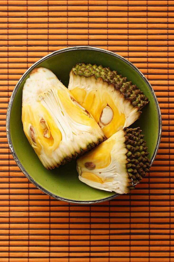 Three piece of jackfruit in a green bowl