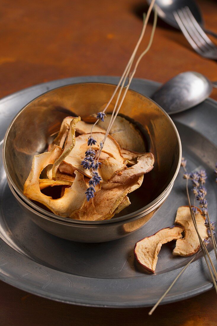 Apple chips with dried lavender on a pewter plate