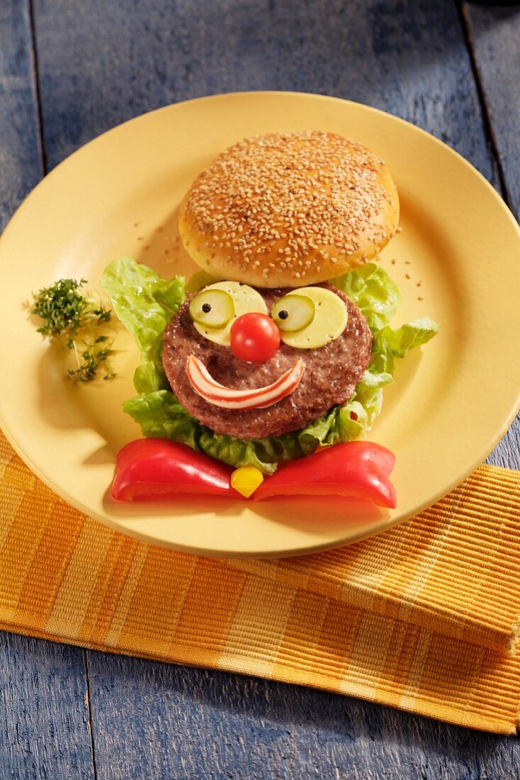 A hamburger with a funny clown face