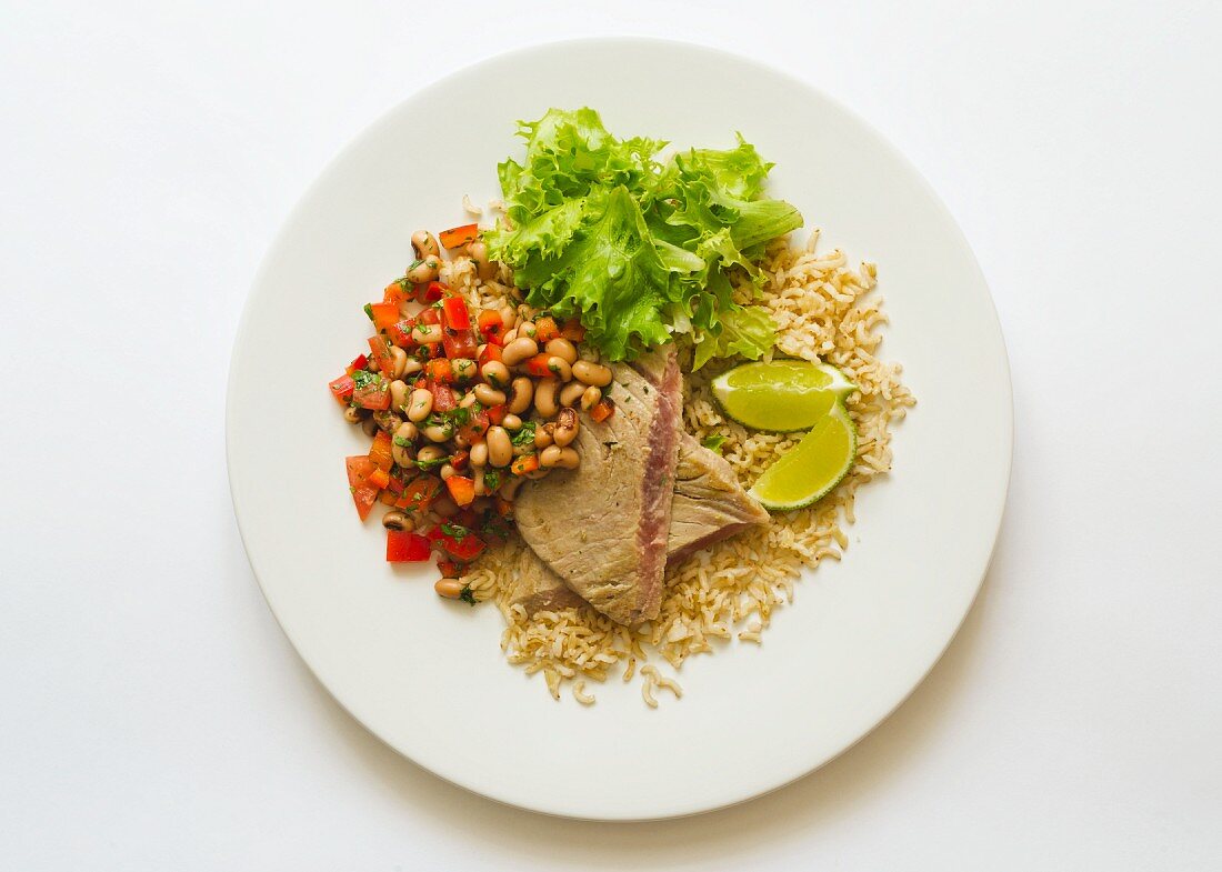 Tuna steaks served with a bean and tomato salad and rice