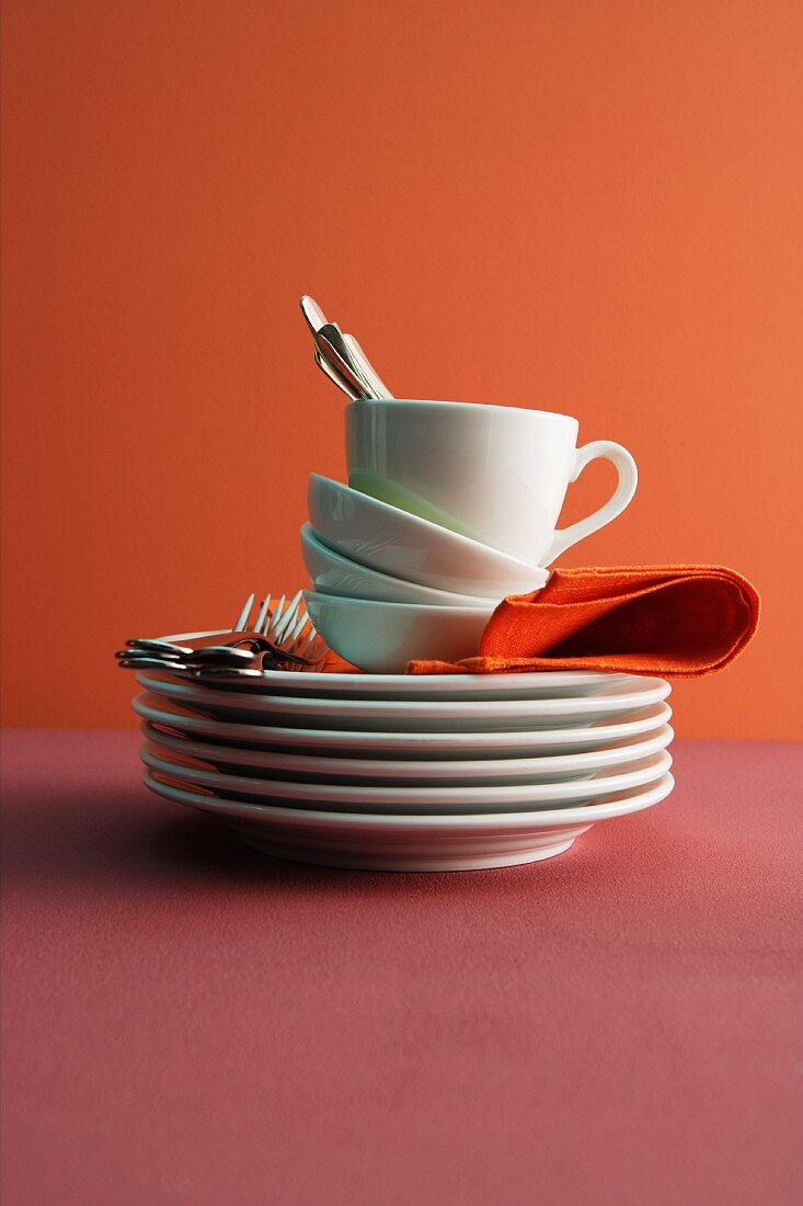 A stack of plates, bowls and a cup