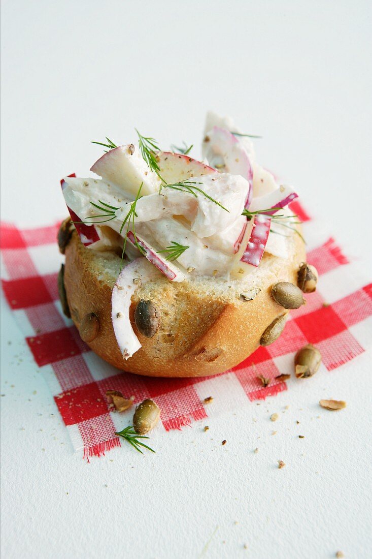Pumpkin seed roll topped with smoked trout and apple salad