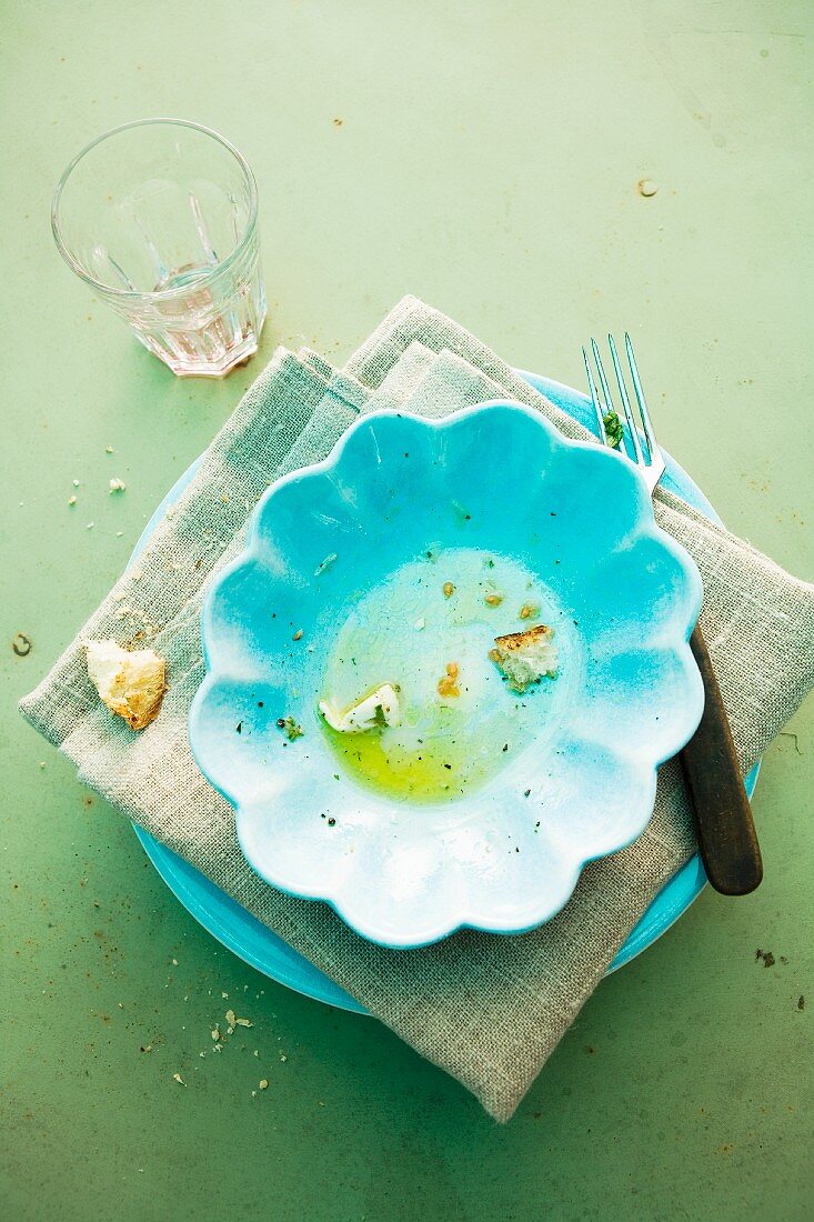 The remains of tortellini with tomato and mozzarella on a plate