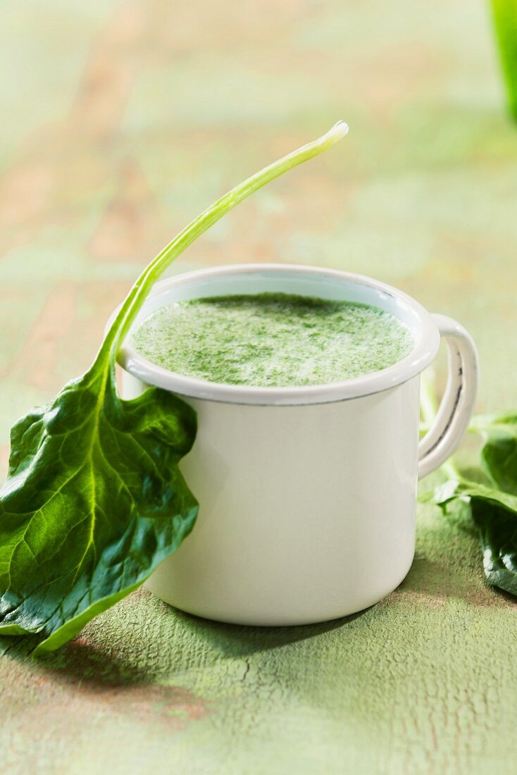 Spinach soup in an enamel mug