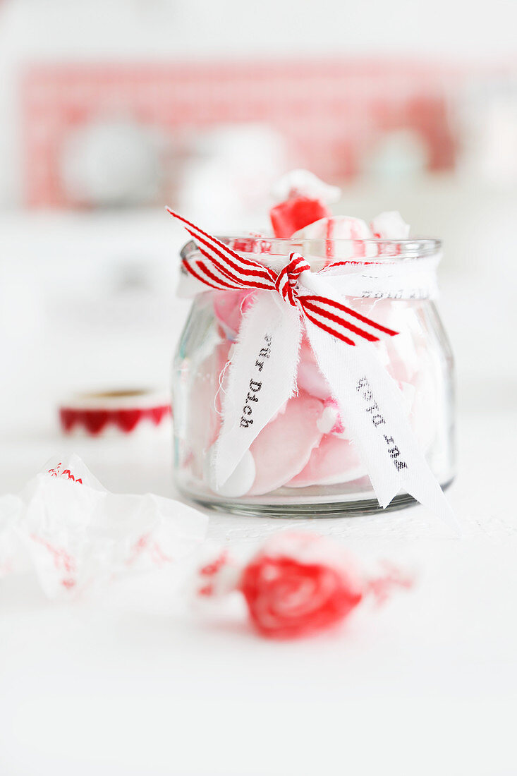 Pink bonbons in a jar as a gift