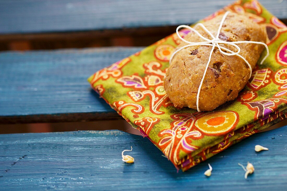 A rolls with wheatgerm seeds on a colourful napkin