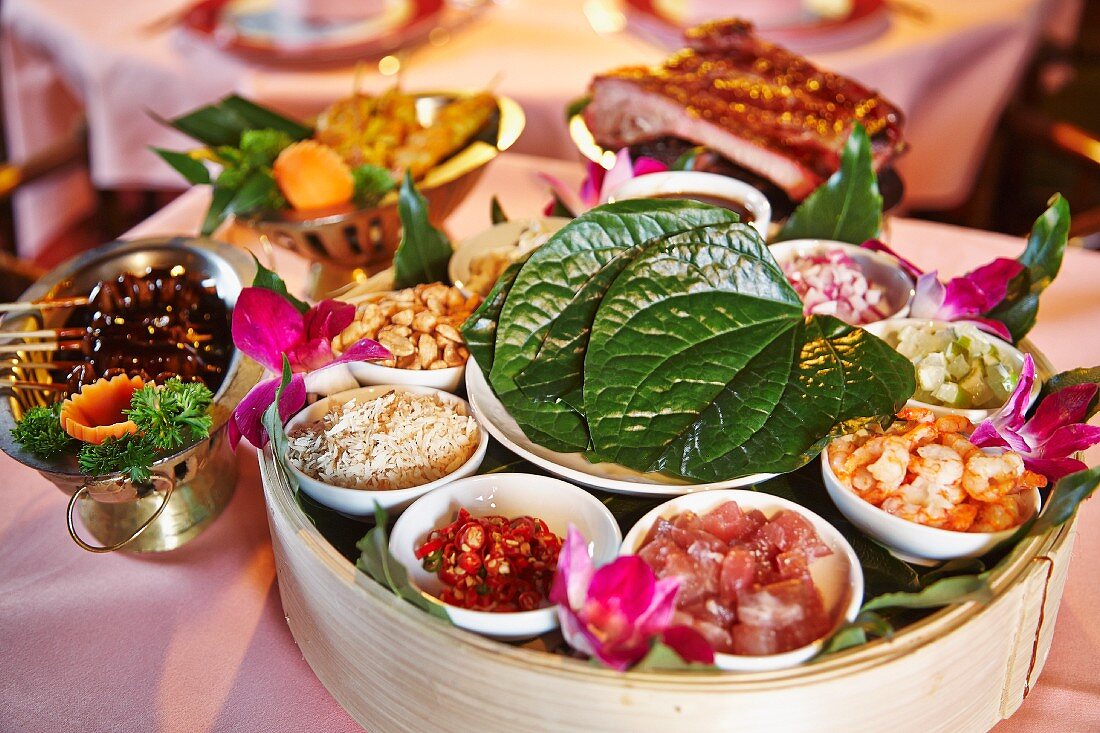 An oriental platter featuring chicken, prawns, cucumber, piri-piri, rice and peanuts