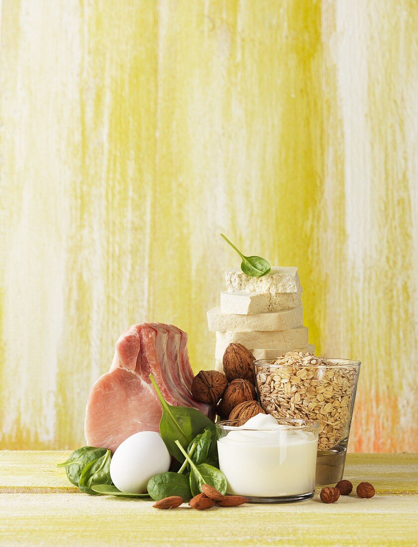 An arrangement featuring pork, an egg, spinach, nuts, dairy products and oats