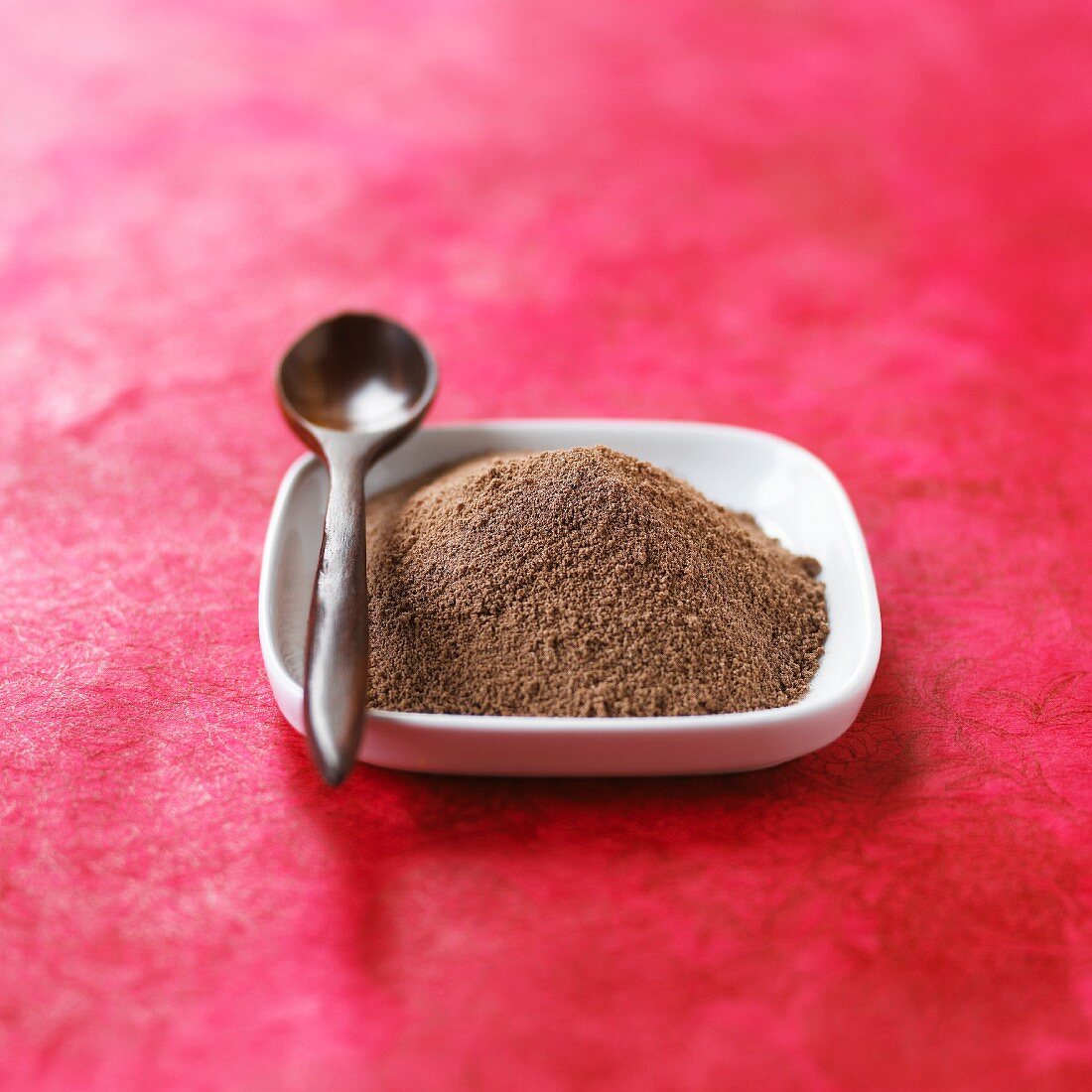 Chocolate powder in a dish with a spoon