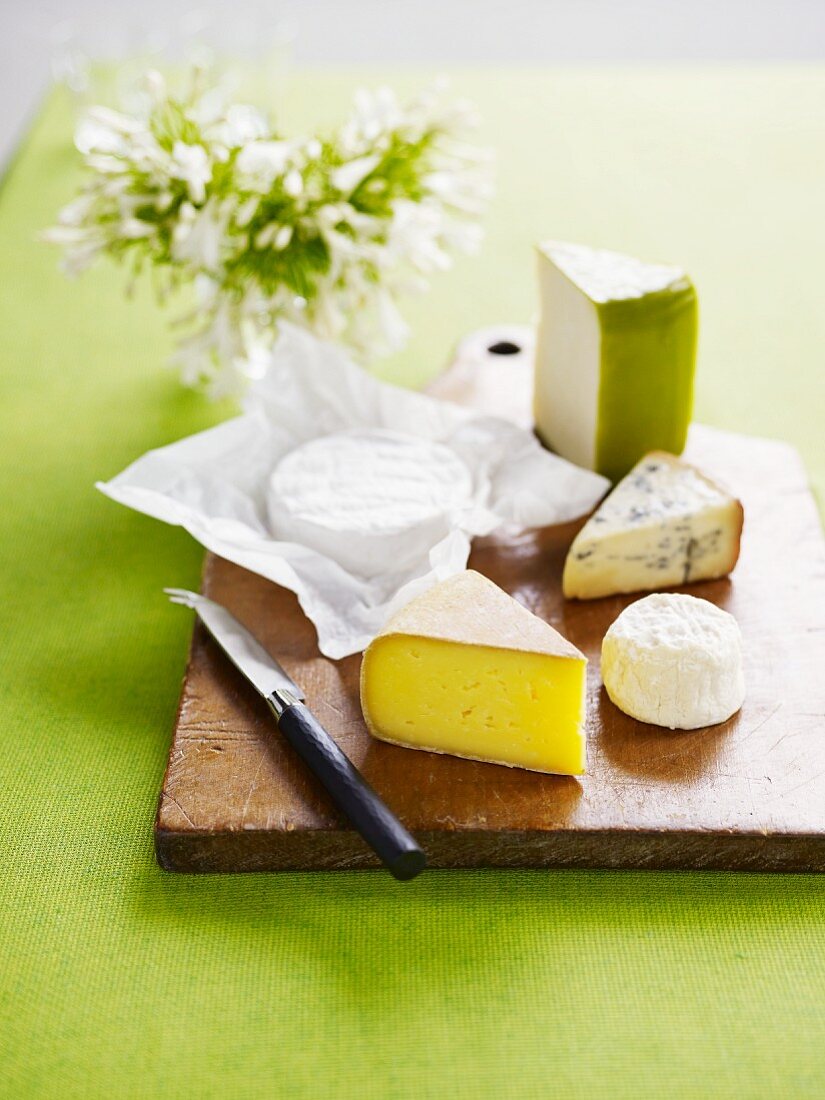 Various types of cheese on a wooden board