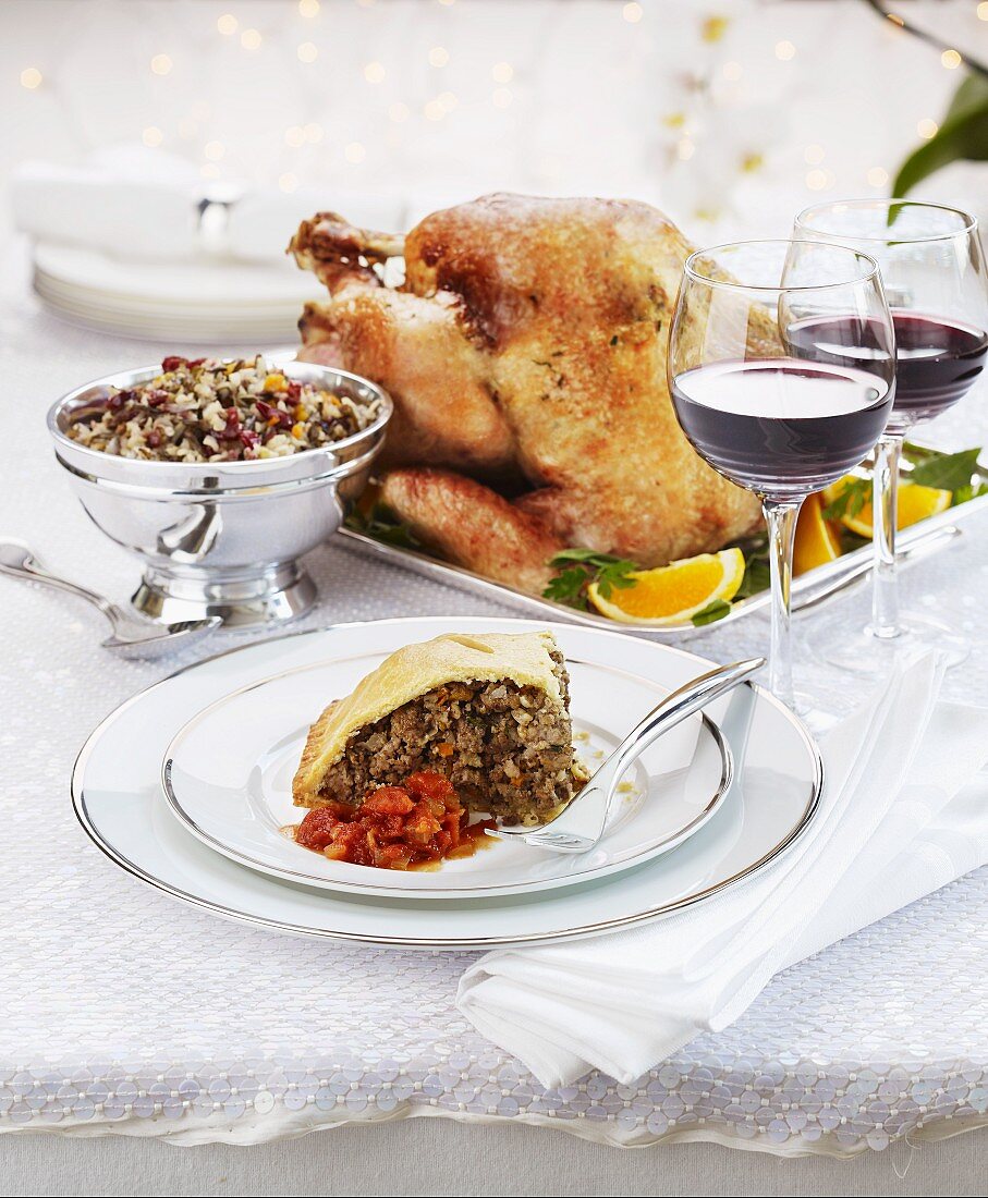 Festive roast turkey with a slice of tourtiere on a plate