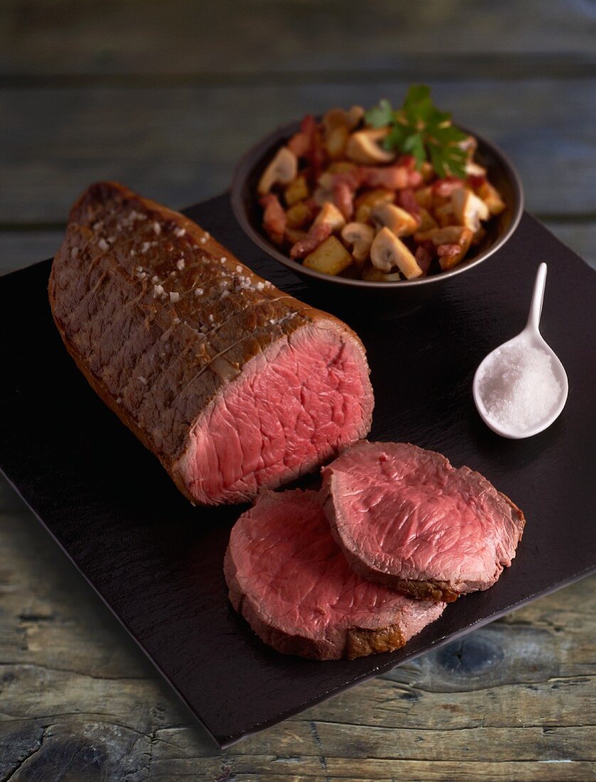 Sliced roast beef with a mushroom and potato medley