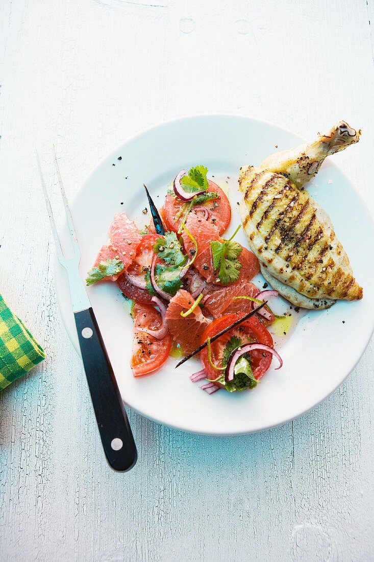 Grilled chicken breast with a grapefruit and tomato salad and a vanilla and lime dressing
